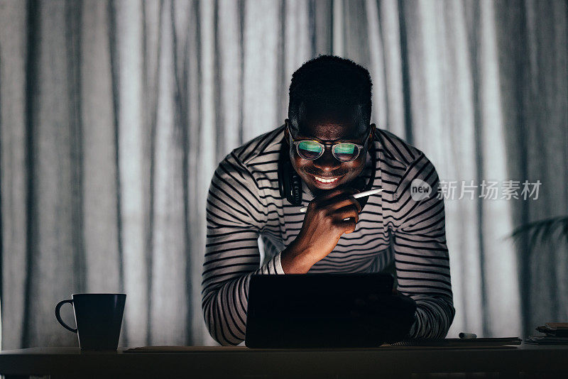 Happy BusinessmanÂ Working At Home On A Digital Tablet